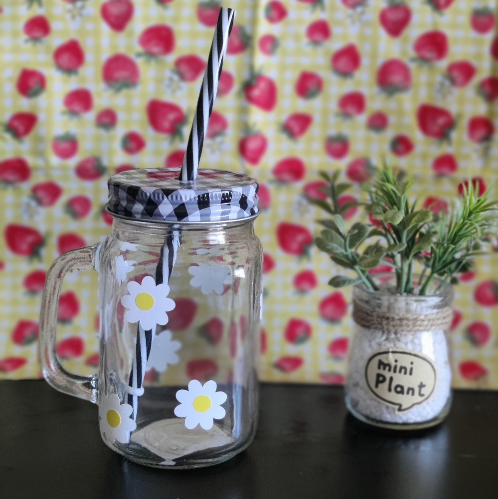 Drinking glass cup with metal lid and a straw